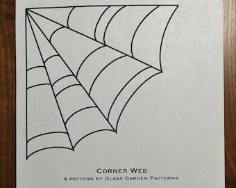May include: A black and white corner web design printed on white paper. The text "CORNER WEB" and "A PATTERN BY GLASS GARDEN PATTERNS" are visible. The pattern is for glass garden patterns and is not to be distributed or sold.
