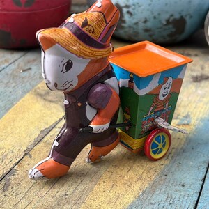 vintage tin toy rabbit pulling a cart