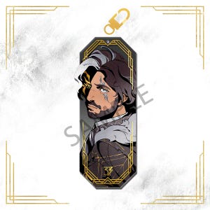 May include: A character art acrylic charm featuring a side profile of a man with dark hair, a beard, and facial markings. The charm has a gold-colored clasp and a decorative gold border. The number "33" is at the bottom.