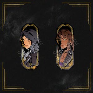 May include: Two decorative bookmarks featuring stylized portraits of individuals with dark hair and intricate clothing. The portraits are set within ornate gold frames against a black background with gold art deco accents. The bookmarks have a unique design.