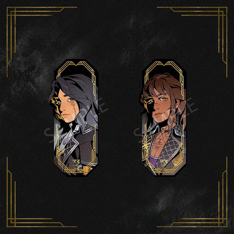 May include: Two decorative bookmarks featuring stylized portraits of individuals with dark hair and intricate clothing. The portraits are set within ornate gold frames against a black background with gold art deco accents. The bookmarks have a unique design.