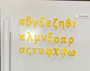 May include: A set of yellow Greek alphabet letter magnets arranged in three rows on a white surface. The letters include alpha, beta, gamma, delta, epsilon, zeta, eta, theta, iota, kappa, lambda, mu, nu, xi, omicron, pi, rho, sigma, tau, upsilon, phi, chi, psi, and omega.