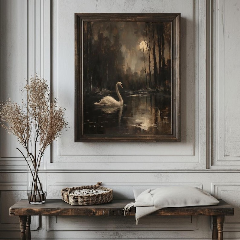 May include: A framed painting of a white swan swimming in a dark, moonlit lake. The swan is in the center of the image, with the moon and trees in the background.