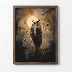 May include: A framed print of a brown and gray owl perched on a branch with a full moon in the background. The owl is looking to the left and the background is a dark brown and gray color.