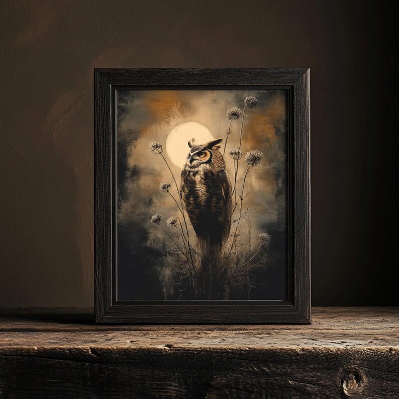 May include: A framed print of a brown and white owl perched on a branch with a full moon in the background. The owl is looking to the left and the moon is a pale yellow color. The background is a dark brown and the branches are a light brown.