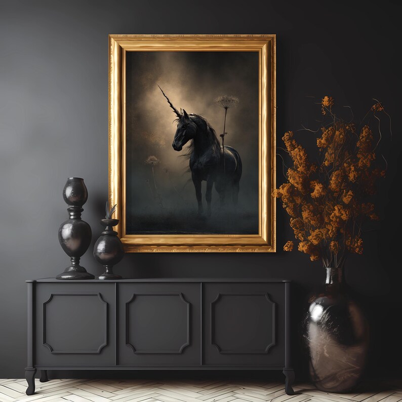 May include: A black unicorn with a single horn stands in a misty forest setting. The unicorn is framed in a gold picture frame and hangs on a black wall above a black cabinet.