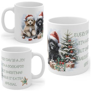 May include: A white ceramic mug featuring a festive illustration of a tan and a black Cockapoo wearing Santa hats, sitting by a decorated Christmas tree and gifts. The text reads: Every day is a joy with a Cockapoo but Christmas makes it extra special.