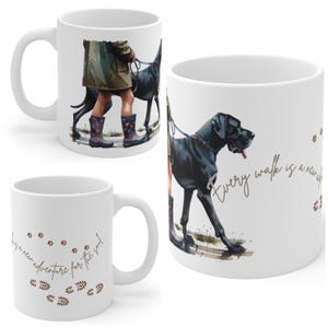 May include: White ceramic mug with a watercolour illustration of a black Great Dane on a lead. The mug features the text "Every walk is a new adventure for the soul" in a cursive font, and paw prints.