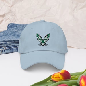 Può includere: Un cappello da baseball blu chiaro con un'immagine ricamata di una volpe fennec con grandi orecchie verdi.