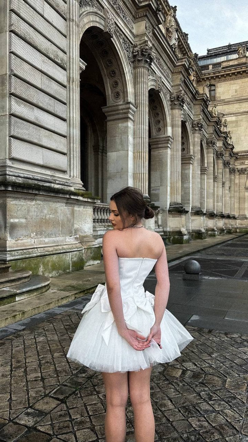 Romantic ivory corset dress with flowing tulle skirt and delicate bows accents timeless beauty. Perfect for weddings or special occasions. image 8