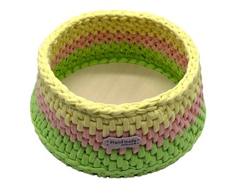 Colorful handmade round crochet basket with wooden base
