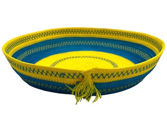 Blue and yellow rope bowl with a tassle and decorative stitching