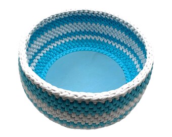 Blue and white handmade crochet basket with wooden base