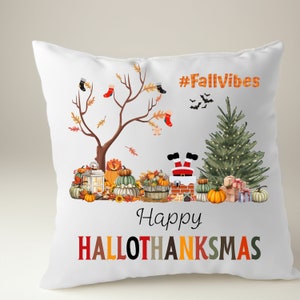 May include: White throw pillow with a festive fall design. The pillow features a tree with red and black socks hanging from the branches, a Santa Claus stuck in a chimney, pumpkins, a lantern, and a Christmas tree. The text on the pillow reads "#FallVibes" and "Happy HalloThanksmas".