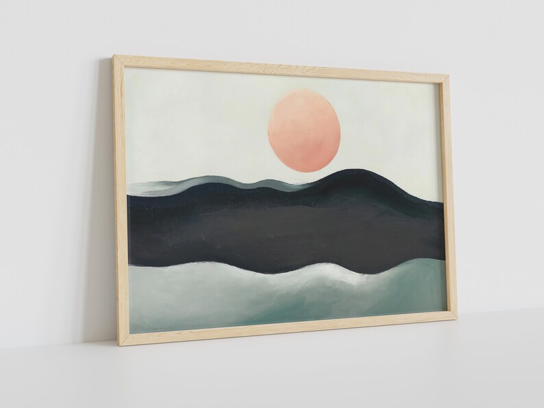 May include: A framed abstract painting with a pink circle in the upper center and a landscape of blue and green waves below.