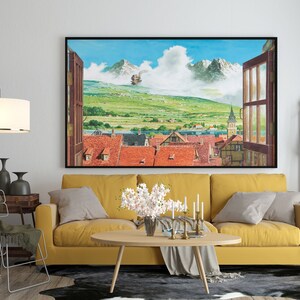 May include: A yellow sofa with two throw pillows sits in a living room with a large framed print of a town scene with a flying airship. The print is above a coffee table with a vase of white flowers and candles.