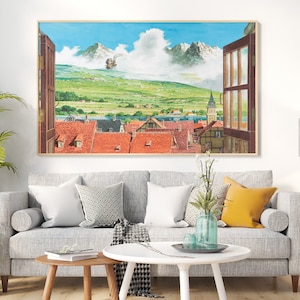 May include: A framed painting of a mountain landscape with a small town in the foreground. The painting is in a living room setting with a gray couch, a coffee table, and a floor lamp.