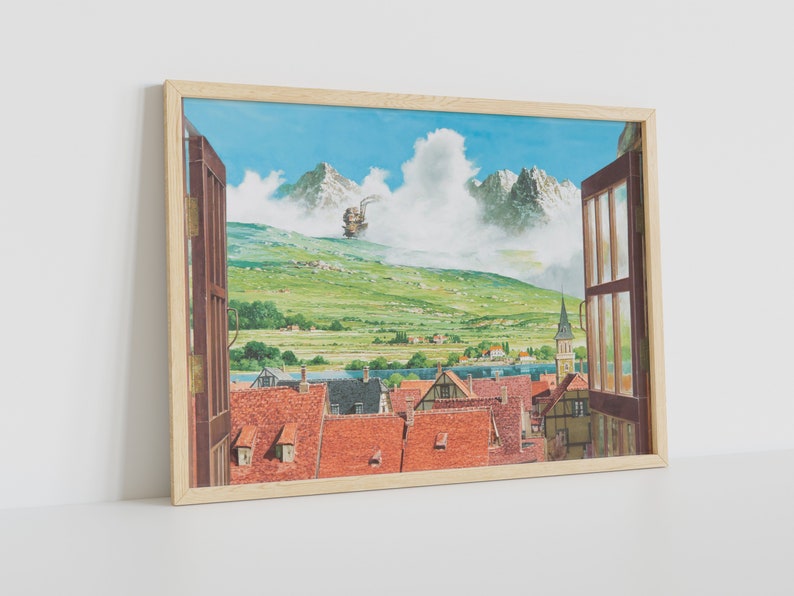 May include: A framed print of a painting depicting a view from a window. The window is open and looks out onto a small town nestled in a valley. The town is surrounded by green hills and mountains. A large, flying machine is visible in the distance, hovering over the mountains. The sky is blue and cloudy.