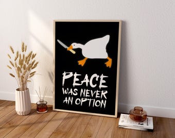 May include: A rectangular framed print featuring a white goose with orange feet and beak holding a silver knife in its mouth against a black background. Below the goose, the white text reads: PEACE WAS NEVER AN OPTION in a bold, distressed font.