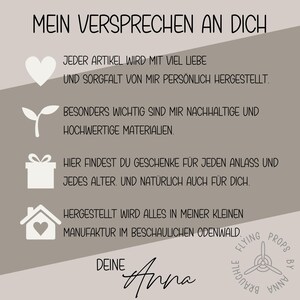 May include: A graphic with text in German, including "MEIN VERSPRECHEN AN DICH" and other phrases. The design features a heart, a plant, a gift box, and a house icon. The text is in a handwritten style, with a logo at the bottom.