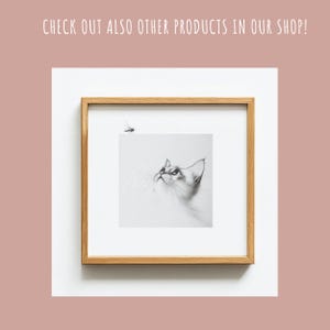 May include: A black and white pencil drawing of a cat looking up at a fly. The drawing is framed in a light wood frame.