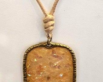 Golden Sparkles necklace! Bright gold with iridescent glittery chunks in an antique gold colored bezel