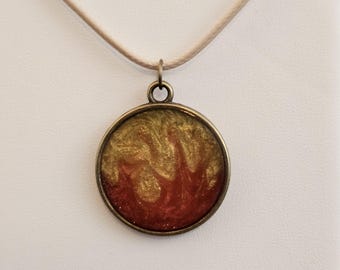 Fire! Swirly Golden and scarlet resin in a round antique brass pendant. Waxed Leather Necklace