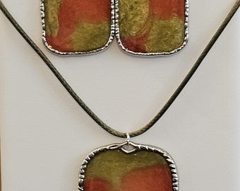 Green/golden and Scarlet shiny, swirly resin in silver bezels. Earrings and necklace set