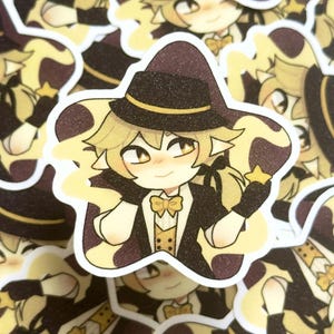 May include: A sticker depicting an anime-style character with blonde hair, dressed in a black suit, hat, and bow tie. The character holds a star, set against a star-shaped background in yellow and brown tones.