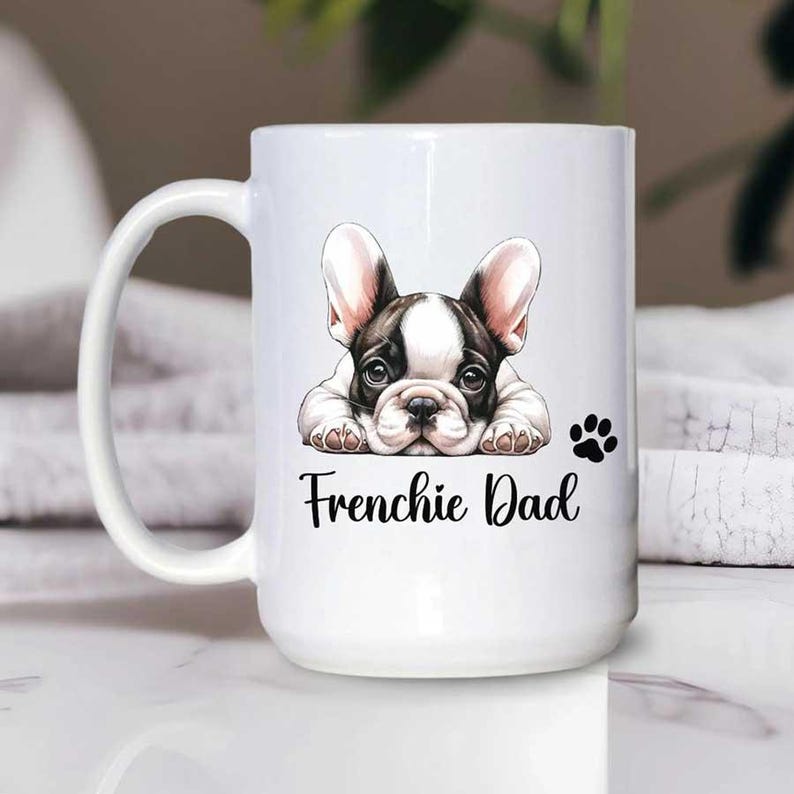 A 15oz white mug French Bulldog dad with a text says Frenchie Dad with a paw print.