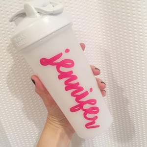 May include: White shaker bottle with a pink "Jennifer" name written on it.