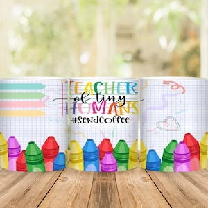 May include: Three white coffee mugs with a teacher theme. The middle mug has the text "Teacher of tiny humans #sendcoffee". The mugs have a grid pattern and colorful crayon drawings.