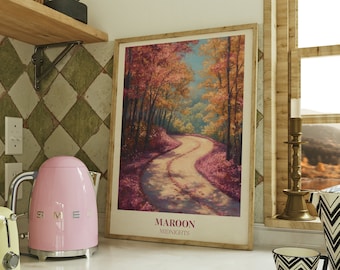 May include: A pink electric kettle with a silver handle and spout sits on a white countertop next to a yellow toaster. A framed poster with a painting of a winding path through a forest with fall foliage is on the wall behind the kettle. The poster has the text "MAROON MIDNIGHTS" at the bottom.