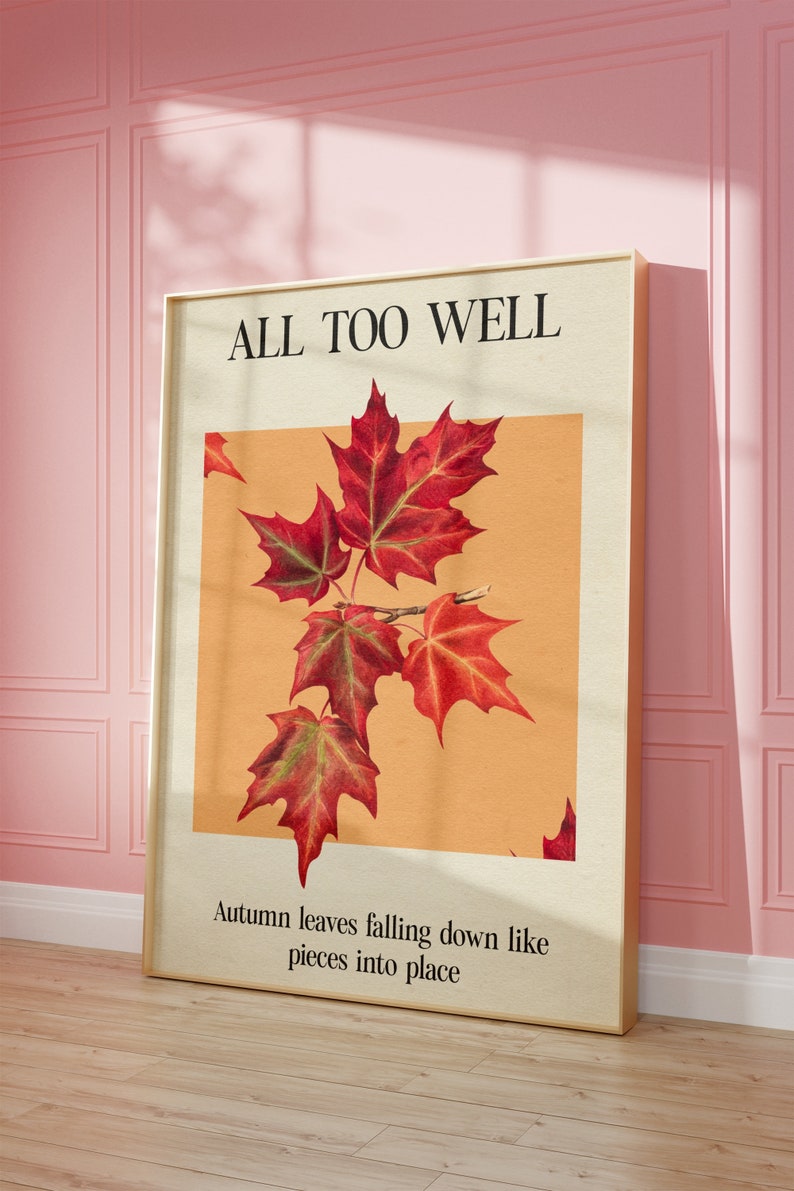 May include: A framed print with the text "ALL TOO WELL" and a picture of red maple leaves on a light orange background. The text below the image reads "Autumn leaves falling down like pieces into place."