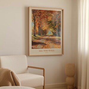May include: A framed print of a painting depicting a path lined with trees in autumn colors. The print has the text "ALL TOO WELL" and "RED" below the image.