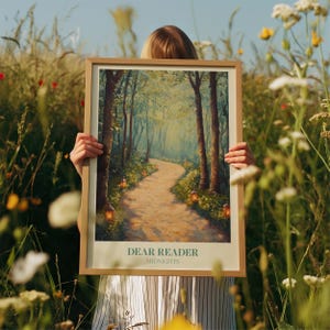 May include: A framed poster with a painting of a path through a forest. The path is lined with trees and there are small lights along the path. The poster has the text "DEAR READER MIDNIGHTS" at the bottom.