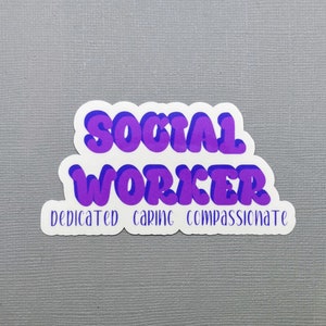 May include: White sticker with purple text that reads "SOCIAL WORKER DEDICATED CARING COMPASSIONATE".