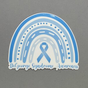 May include: Blue and white rainbow sticker with a blue ribbon in the center and the text "DiGeorge Syndrome Awareness".
