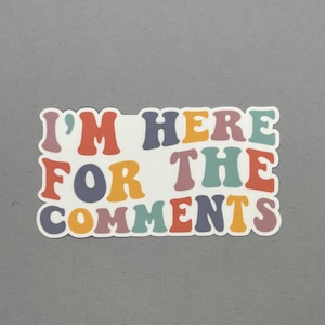 May include: A sticker with the text "I'm here for the comments" in a colorful retro font.