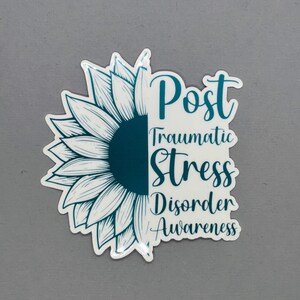 May include: Teal blue sticker with a white sunflower graphic and the text "Post Traumatic Stress Disorder Awareness".