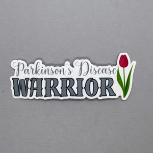 May include: A white sticker with the text "Parkinson's Disease WARRIOR" in gray lettering. A red tulip with a green stem is to the right of the text.
