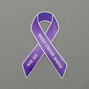 May include: A purple awareness ribbon with the text "MOEBIUS SYNDROME WARRIOR" and "NAME HERE" in white. The ribbon is on a gray background. The ribbon is a symbol of support for those affected by Moebius Syndrome.