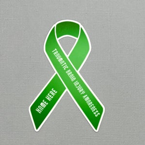 May include: Green ribbon with the text "Traumatic Brain Injury Awareness" and "Name Here" on it.