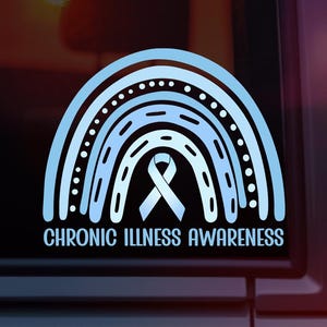 May include: A light blue vinyl decal featuring a stylized rainbow design with a central awareness ribbon. The text CHRONIC ILLNESS AWARENESS is printed in a clean, sans-serif font at the bottom of the graphic, which is applied to a dark surface.