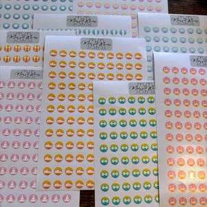 May include: A set of 10 sheets of colorful round stickers with various fitness-themed icons. The icons include a dumbbell, a running shoe, a yoga pose, and a water bottle. The stickers are perfect for adding a touch of personality to planners, journals, and laptops.