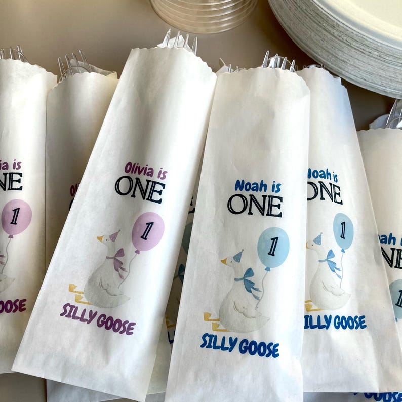 Personalized silverware bag shown as a cutlery and paper napkin holder idea for a child’s birthday party. One Silly Goose Birthday Girl Personalize Silverware Bag Boy Baby 1st Birthday Favor Custom Cutlery Bag Table Decor Paper Napkin Holder Idea