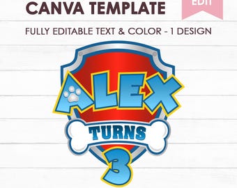 May include: A digital graphic design featuring a red and blue shield emblem with a white bone shape across the center. The text reads ALEX TURNS 3 in blue letters. The design includes a paw print icon and is labeled as a custom paw sign Canva template.