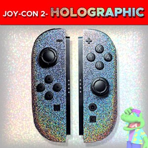 May include: A pair of game controllers with a holographic glitter finish. The left controller features a joystick, directional buttons, and a square button. The right controller has a joystick, A, B, X, Y buttons, a plus sign, a home icon, and a square button.