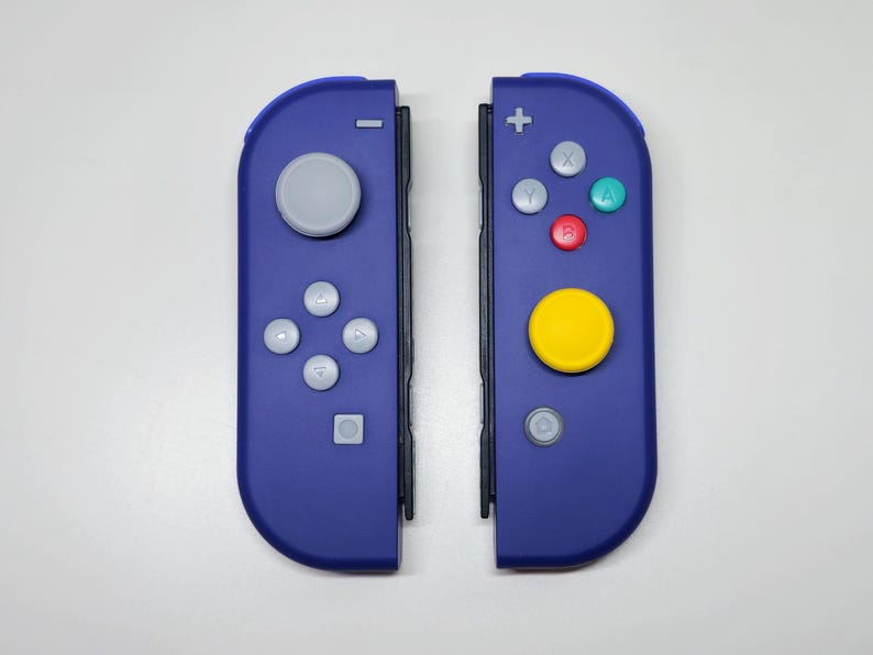 May include: A pair of blue Nintendo Switch Joy-Con controllers with gray buttons and a yellow button on the right controller.