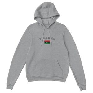 May include: A gray hooded sweatshirt with the text "Benghazi" and the Libyan flag printed on the front.